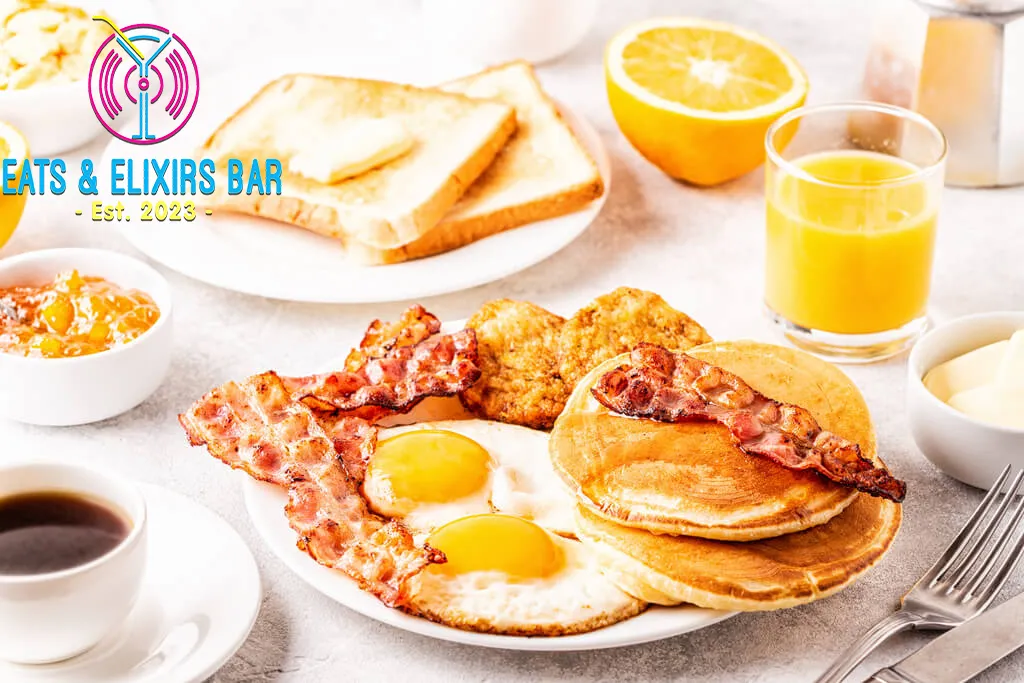 A breakfast of eggs, bacon, pancakes, and orange juice